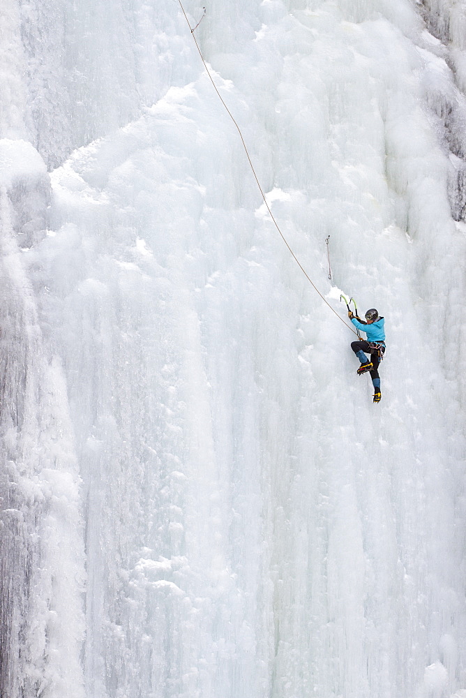 A  woman ice climbs on Blodgett Falls in the Bitterroot Mountains of Montana.