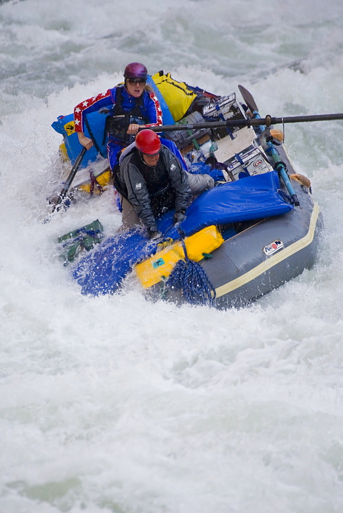 Two women on an inflatable raft going through a rapid, Grand Canyon, Arizona.