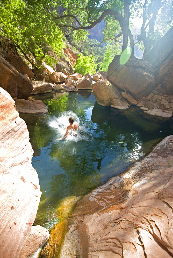 Man jumping into pool, Zion National Park, Utah.