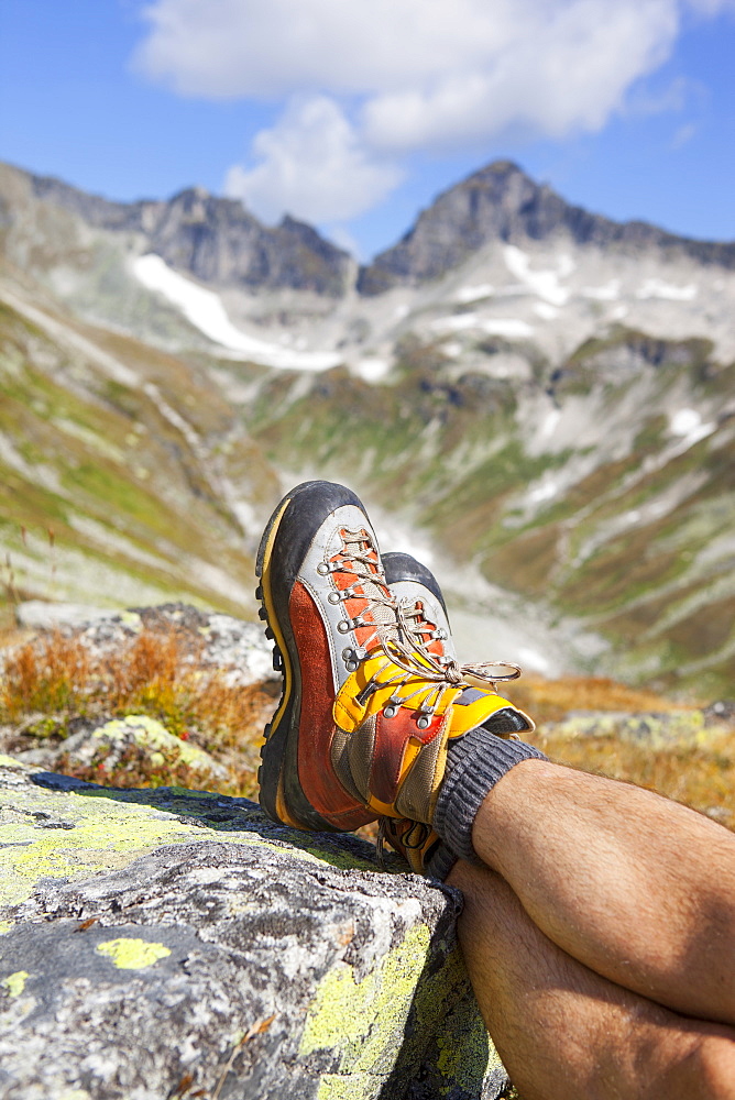 A male hiker takes a rest during the Glocknerrunde, a 7 stage trekking from Kaprun to Kals around the Grossglockner, the highest mountain of Austria.