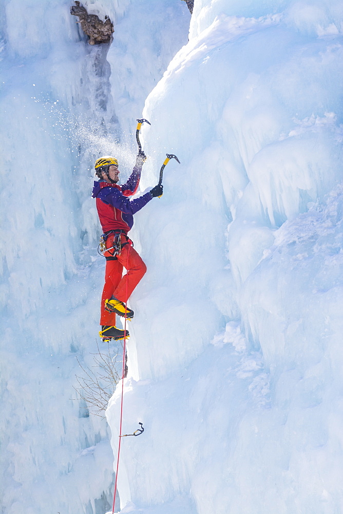 A man ice climbing near Ouray, Colorado.