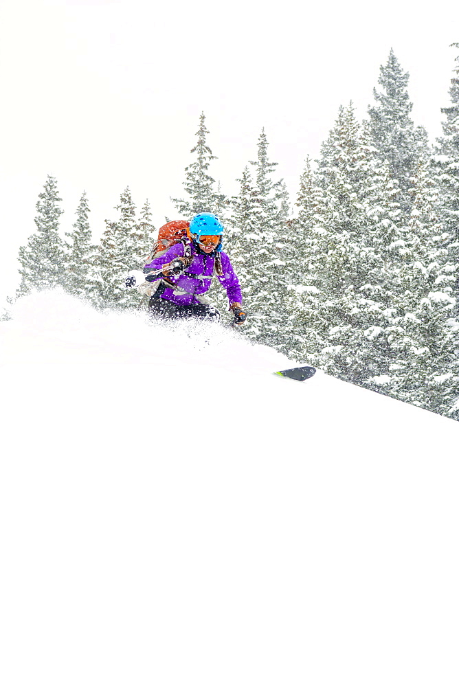 A woman backcountry skiing above Red Mountain Pass, Silverton, Colorado.