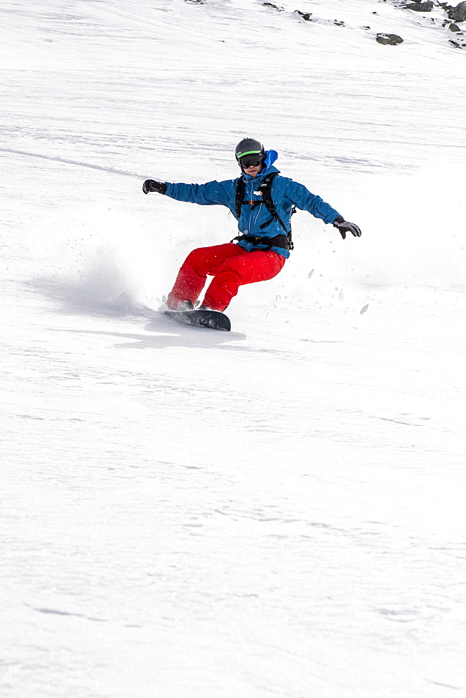 Snowboarder Making A Turn In Fresh Snow Powder