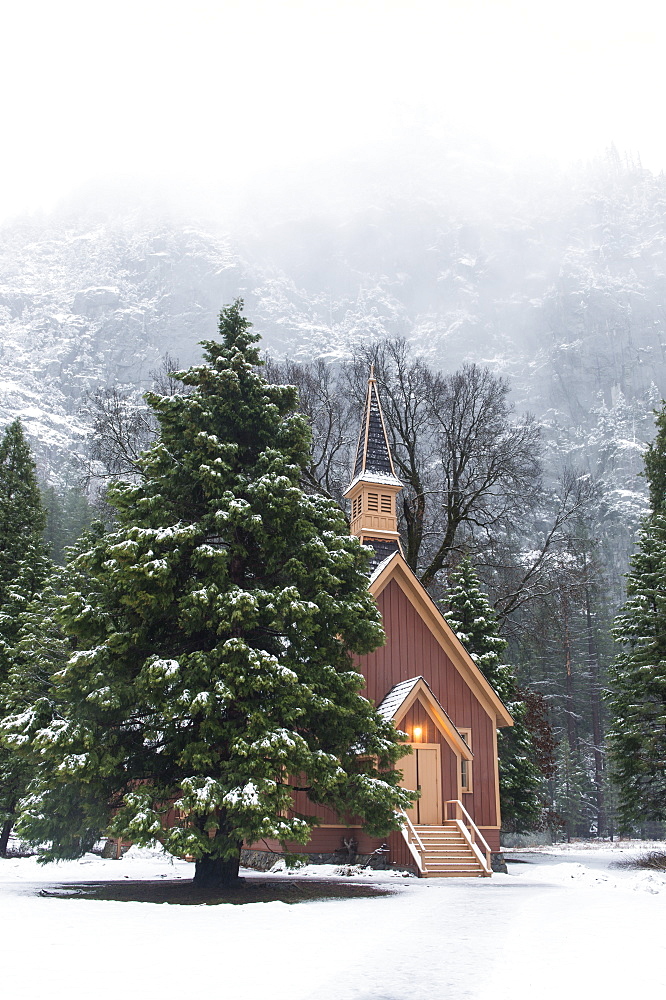 Yosemite Church During Winter With Foggy Mountains In The Background