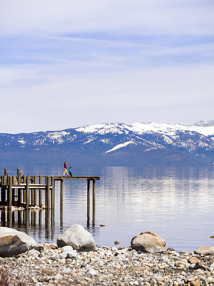 Mother With Her Son Walking On Boardwalk Exploring Lake Tahoe In California, Usa