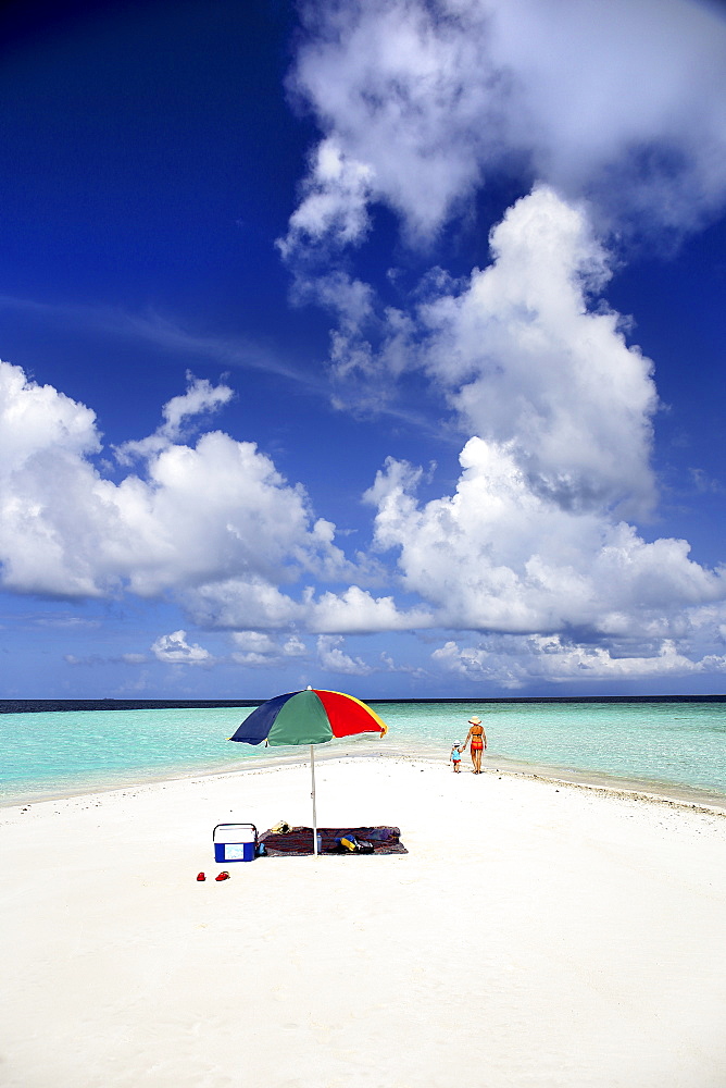 Tourist Strolling And Sunbathing Around A Small Sandbank In Gulhi, Maldives