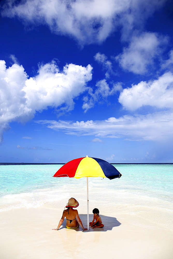 Mother And Child Relaxing On The Beach Of Maldives Island Of Gulhi