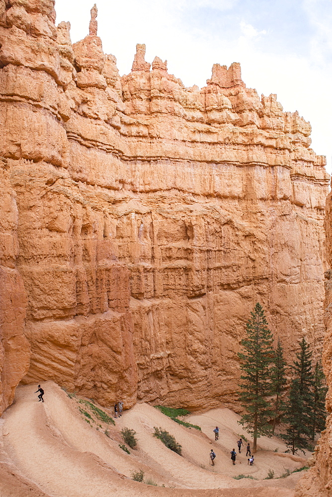 People Walk A Winding Trail In Bryce Canyon National Park