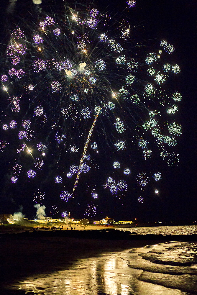 Fireworks explode over the ocean on Cape Cod, MA.