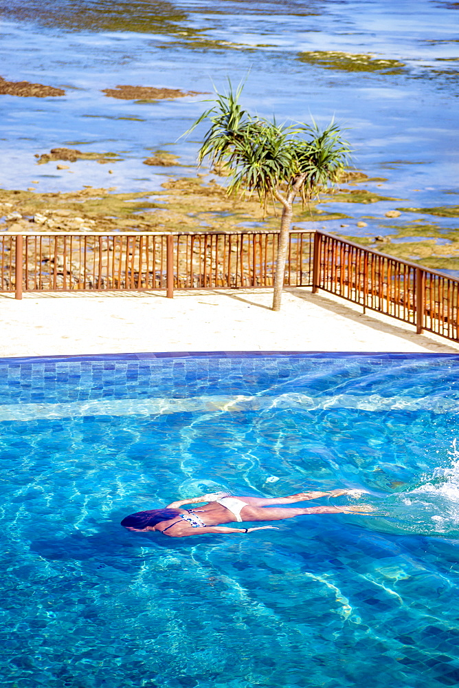 Young woman swimming in pool