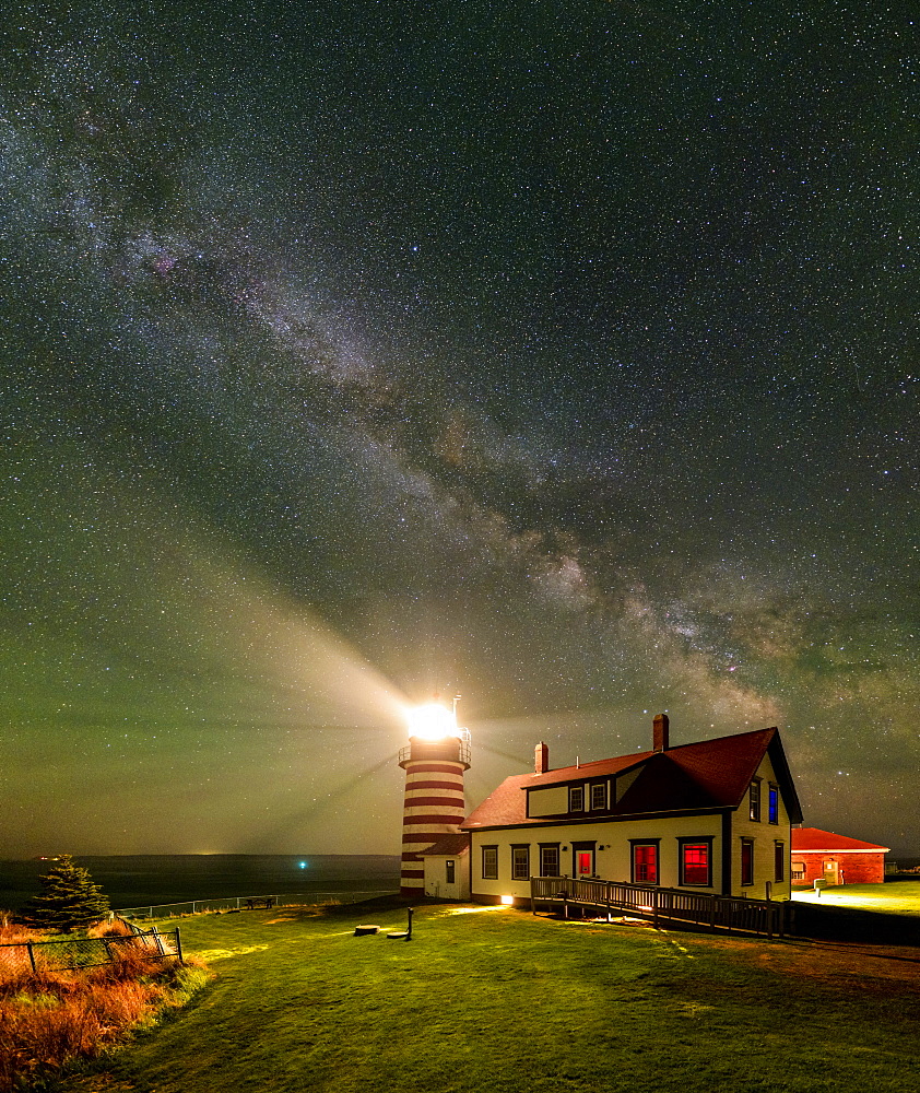 A vertical panorama of the Milky Way over West Quoddy Head Lighthouse in Maine.