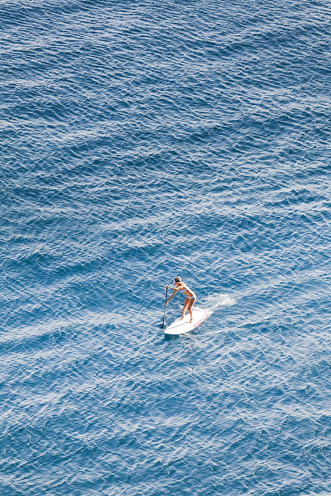 SUP girl enjoying in a beautiful sea