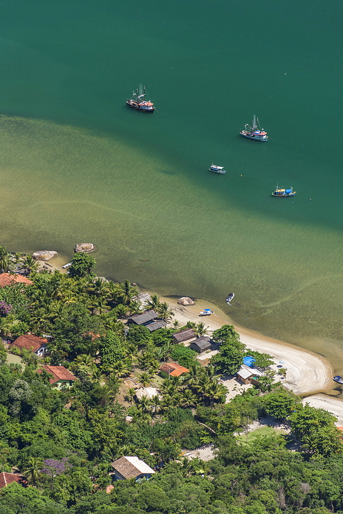 View of fishing village and fishing boats in sea from Mamangua Peak, Saco do Mamangua, Paraty, Costa Verde, Brazil