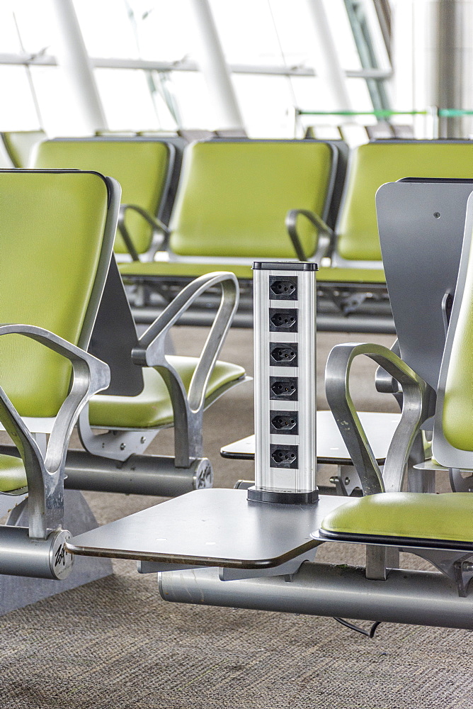 Row of electrical outlets between empty chairs in Brasilia International Airport, Brasilia, Distrito Federal, Brazil