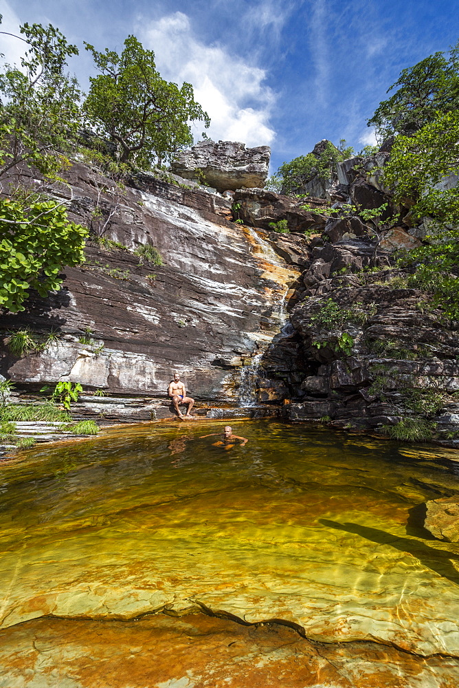 Two men bathing near Cachoeira do Abismo Abyss Waterfall, Chapada dos Vedaeiros, Goias, Brazil