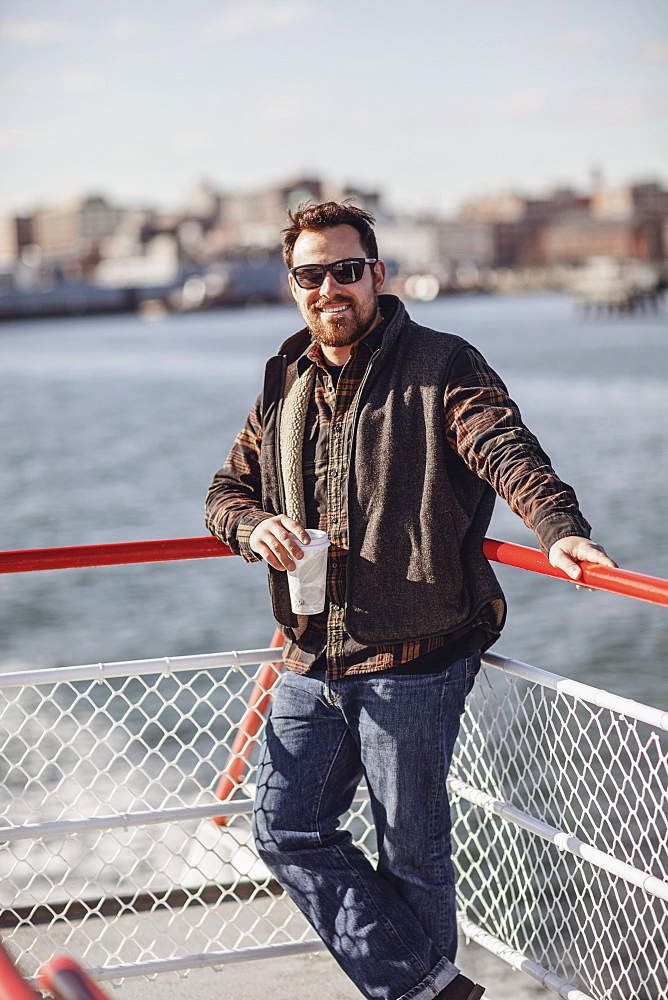 Portrait of bearded man wearing sunglasses riding ferry to Peaks Island, Portland, Maine, USA