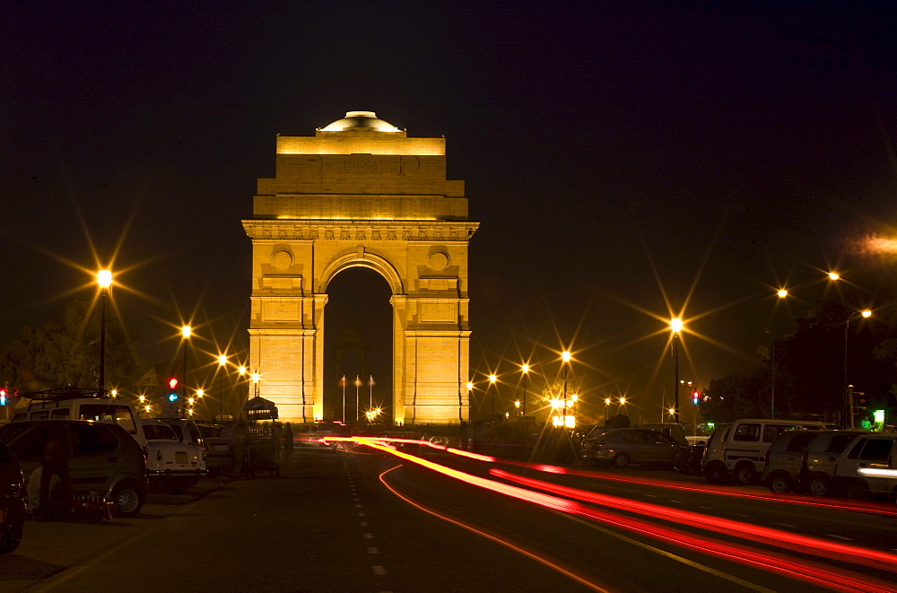 A Road Running Through A Gate At Night; New Delhi India