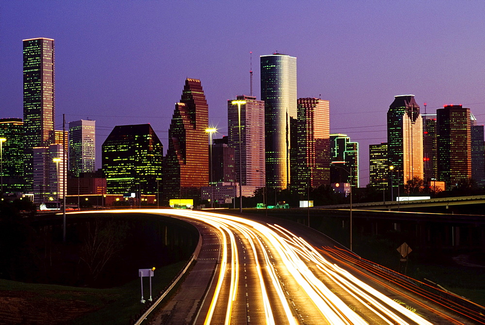 Streaking Car Lights At Night And Downtown Houston In Usa