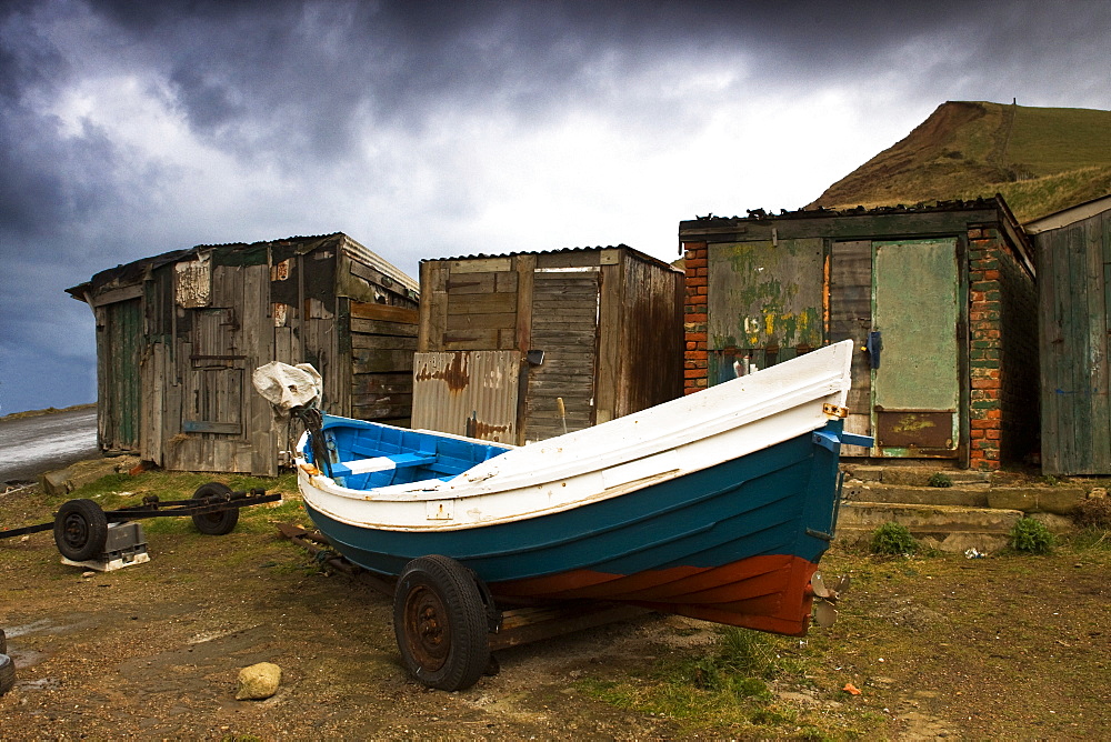 Boat Beside Old Shacks