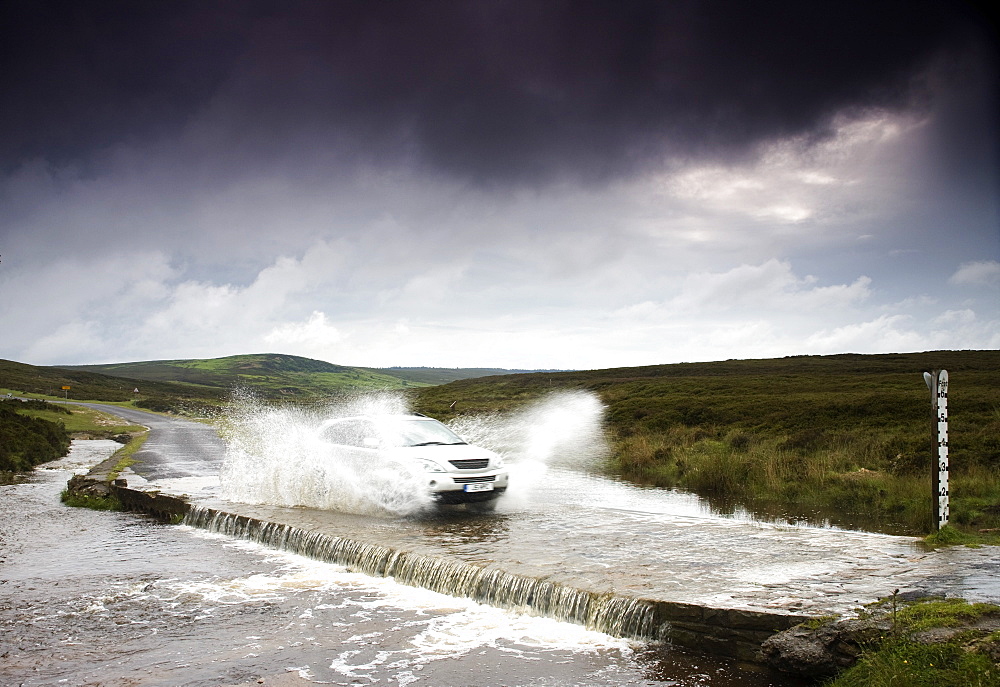 Car Driving Down Flooded Road, Yorkshire, England
