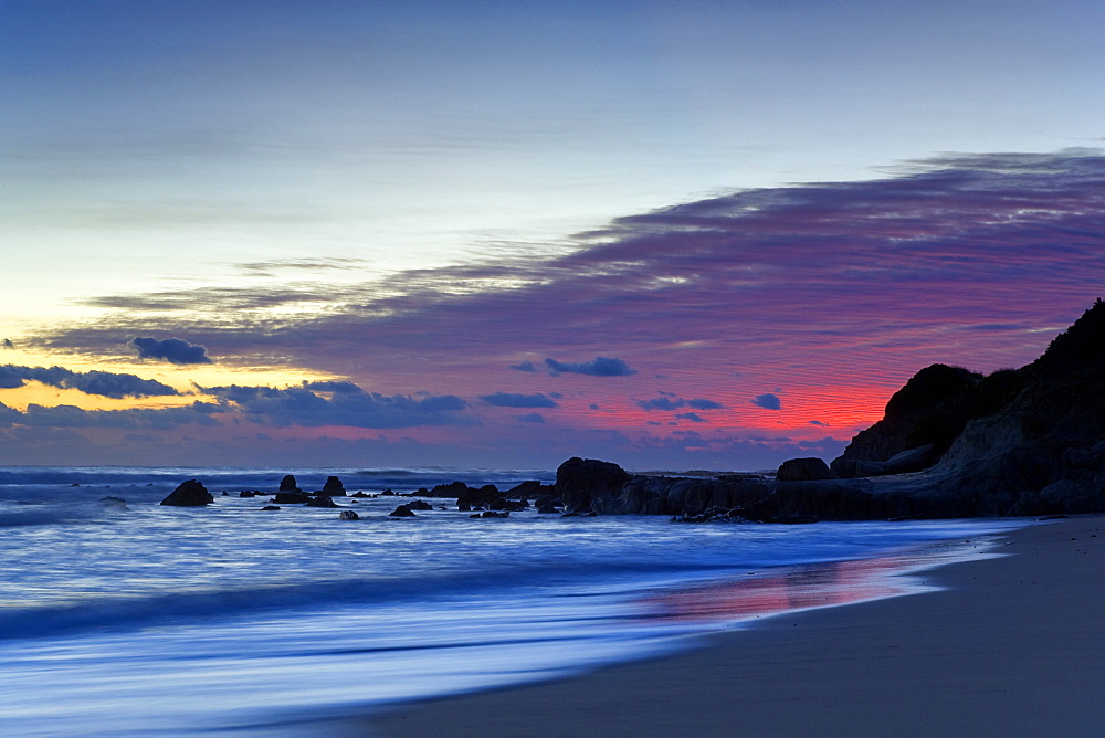 Sunset Over Water And A Beach
