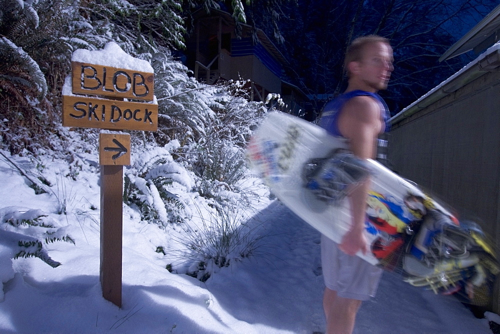 Man Holding A Wakeboard, Wakeboarder In Shorts In The Snow