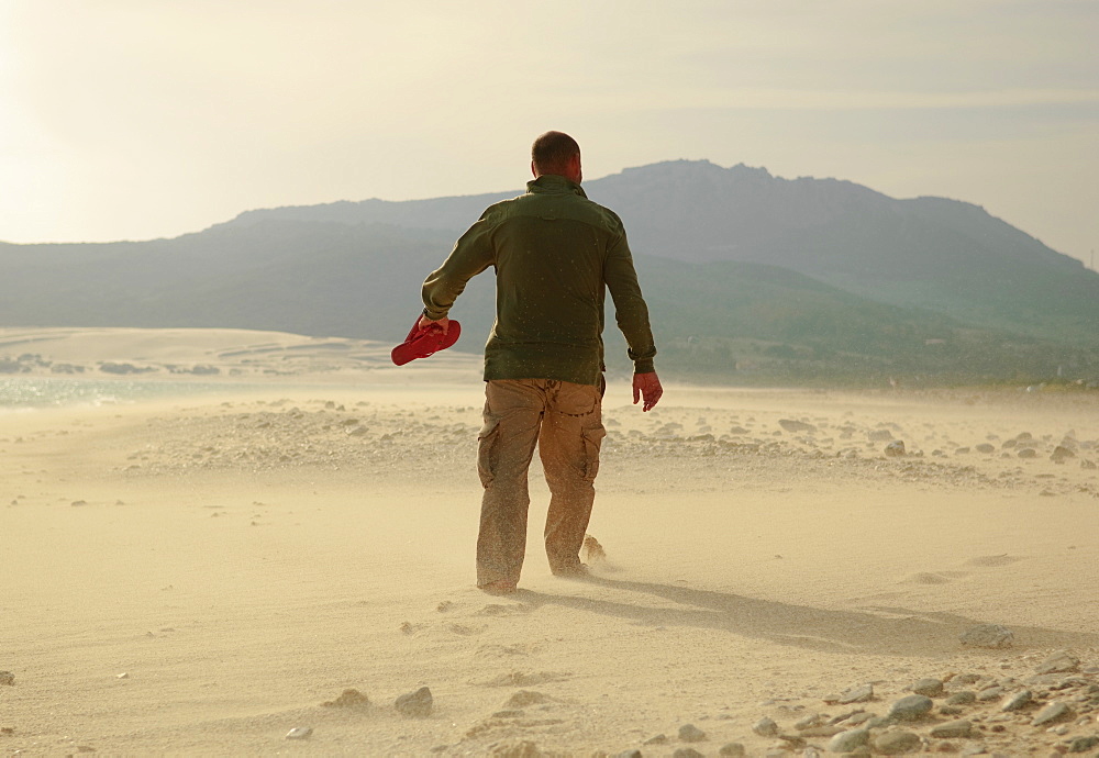 Man Walking On Sand