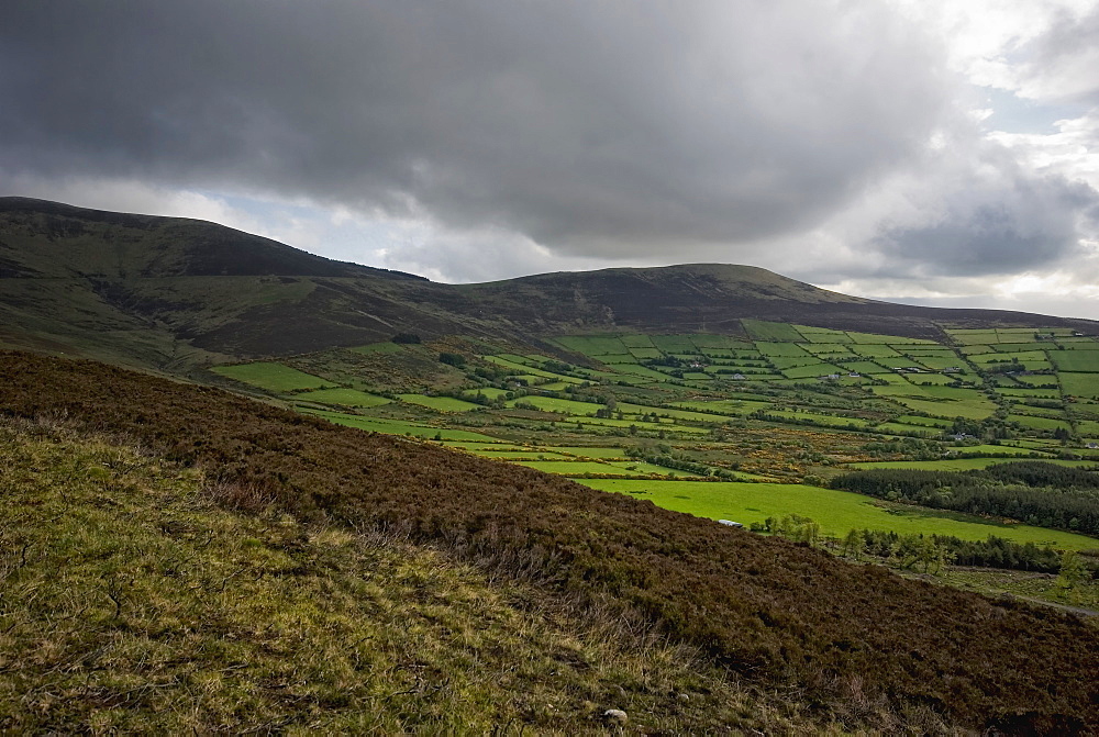 Landscape With Rolling Hills And Dark Clouds In The Sky