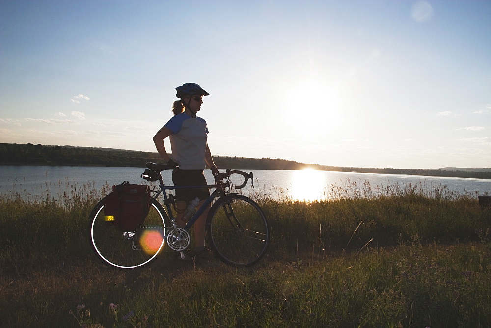 Woman With Bike Along A Lake