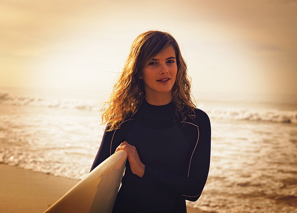 A Young Woman With Her Surfboard At The Beach, Tarifa, Cadiz, Andalusia, Spain