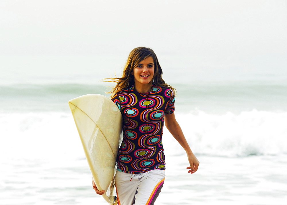 Young Woman Running With Her Surfboard, Tarifa, Cadiz, Andalusia, Spain