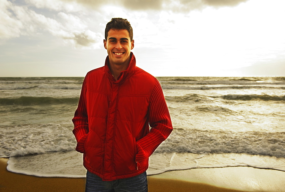 A Young Man Standing On A Beach, Tarifa, Cadiz, Andalusia, Spain
