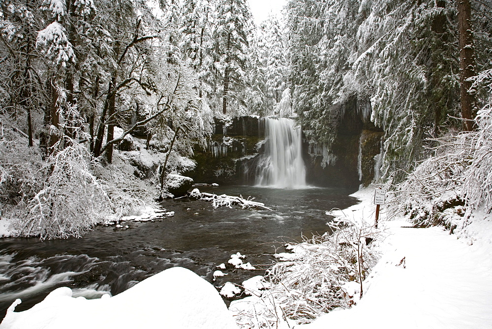 A Waterfall In To A River In Winter