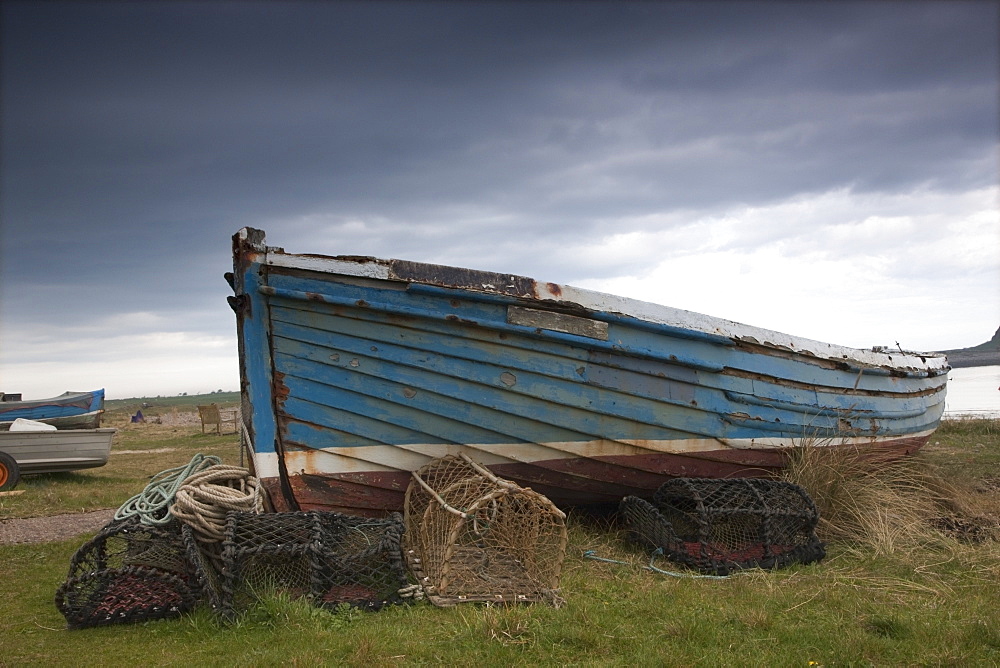 Lindisfarne, Northumberland, England, A Boat And Fishing Traps On The Shore