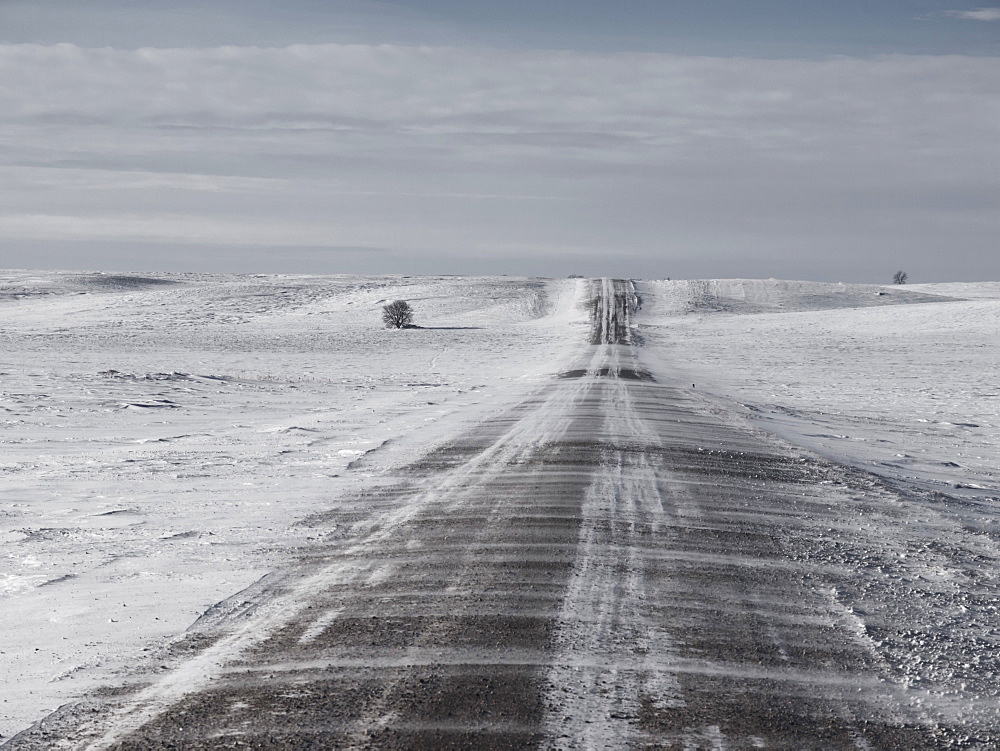 Morden, Manitoba, Canada, Snow Blowing Over A Gravel Road In Southern Manitoba