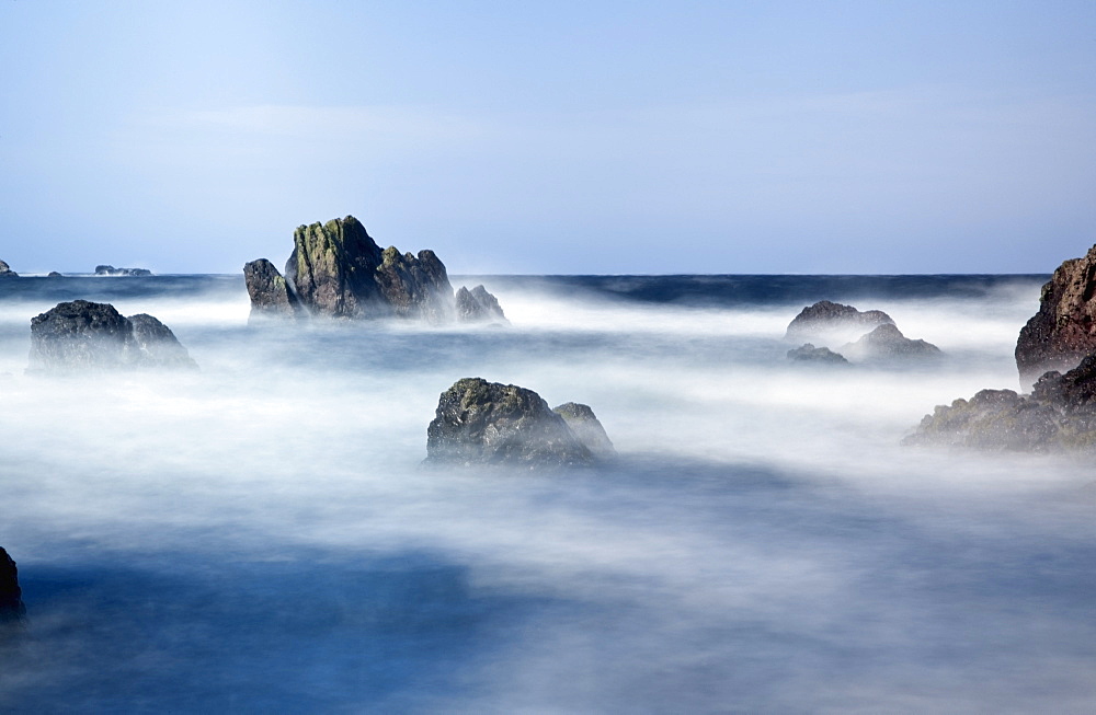 Mist Surrounding Big Rocks In The Water, Northumberland, England