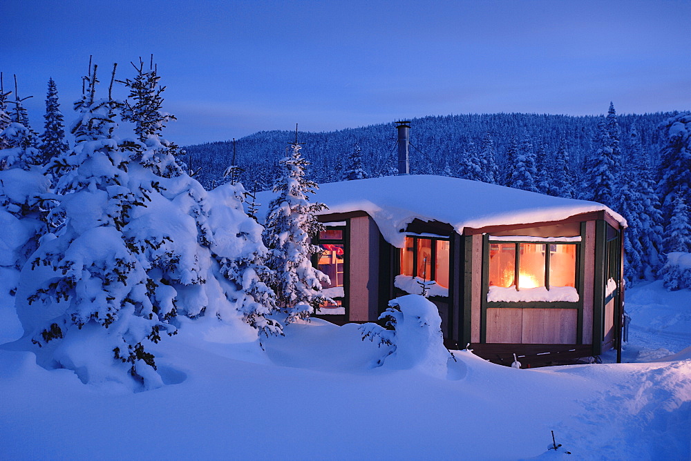 View Of La Mesange Shelter And Snow-Covered Trees At Twilight, Quebec, Canada