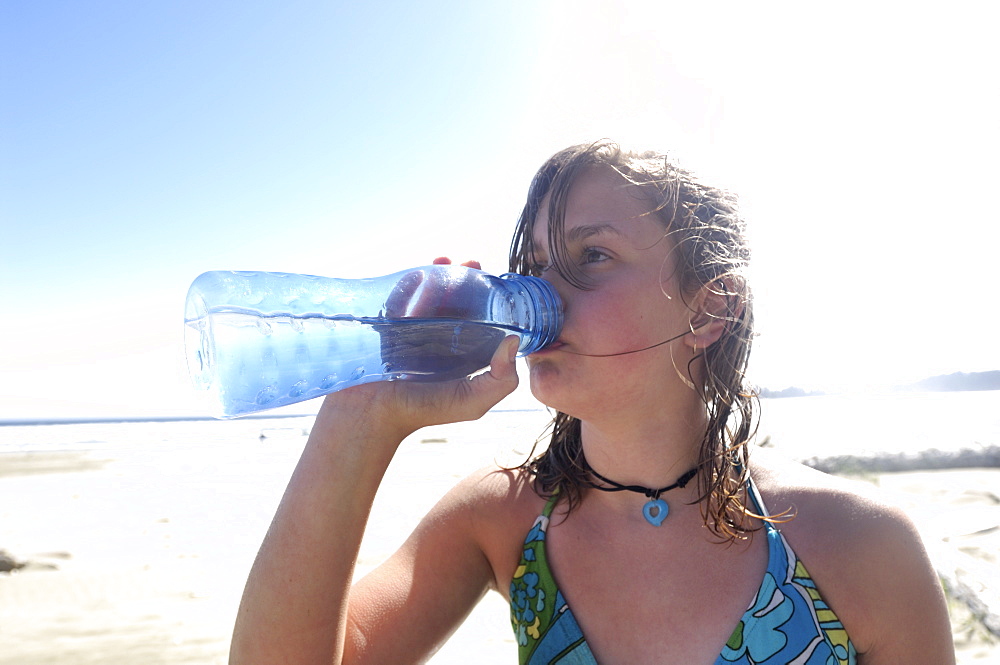 Girl Drinking Clean Water From Refillable Container, On Beach, Vancouver Island, Canada