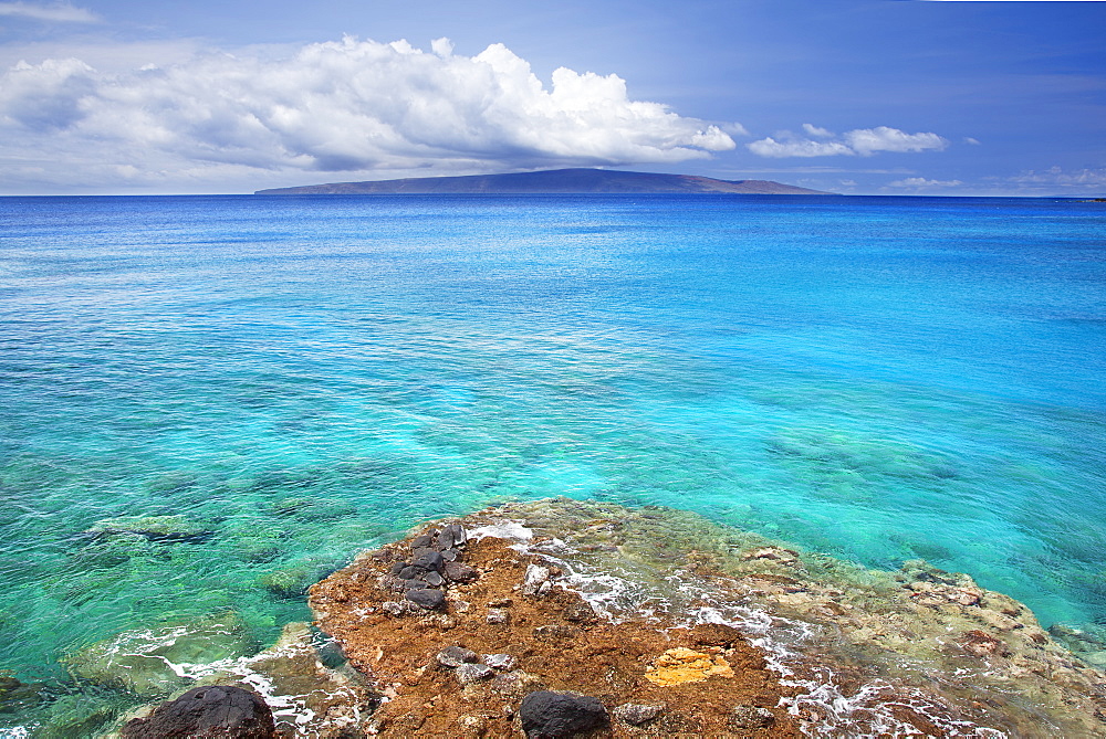 A view of la perouse bay with clear water and coral with kooholawae in the distance, Maui hawaii united states of america