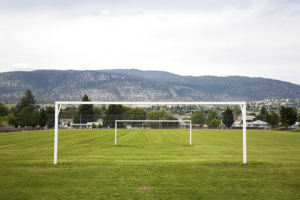 Goal posts in a row in a grass recreation field, British columbia canada