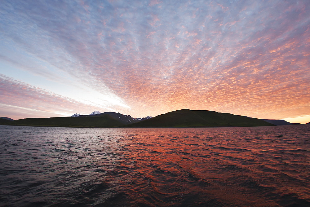 Sunset Behind A Ridgeline From The Water Near Cold Bay, Southwest Alaska, United States Of America