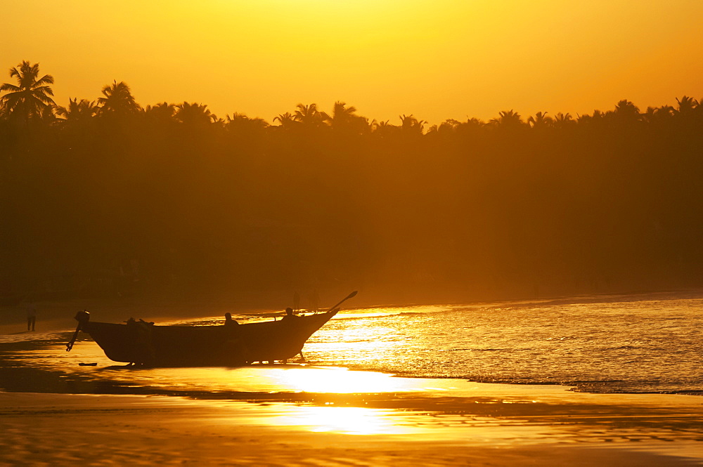 Fishing boat at sunset on palolem beach, Goa karnataka india