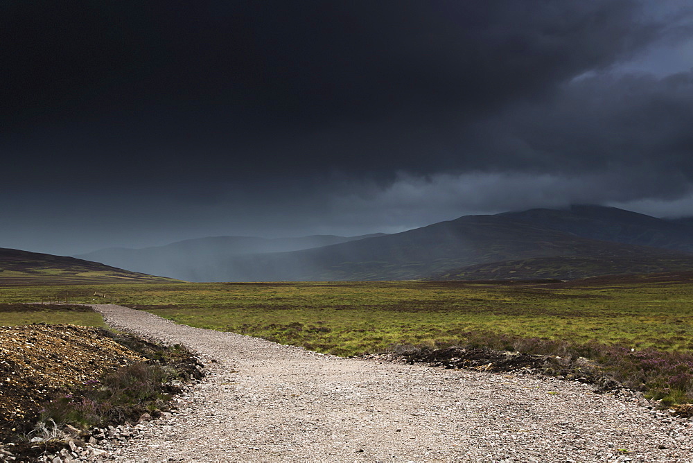 A gravel path under dark storm clouds, Highlands scotland