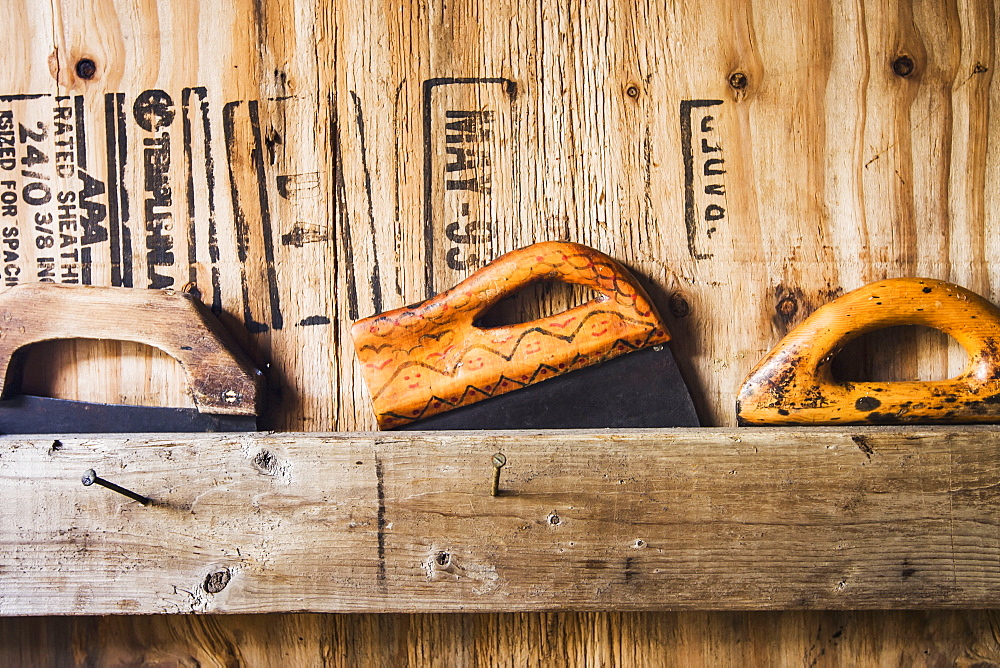 Three ulu knives stored behind a board in a smoke house used for filleting and stripping subsistence salmon, Bristol bay alaska united states of america