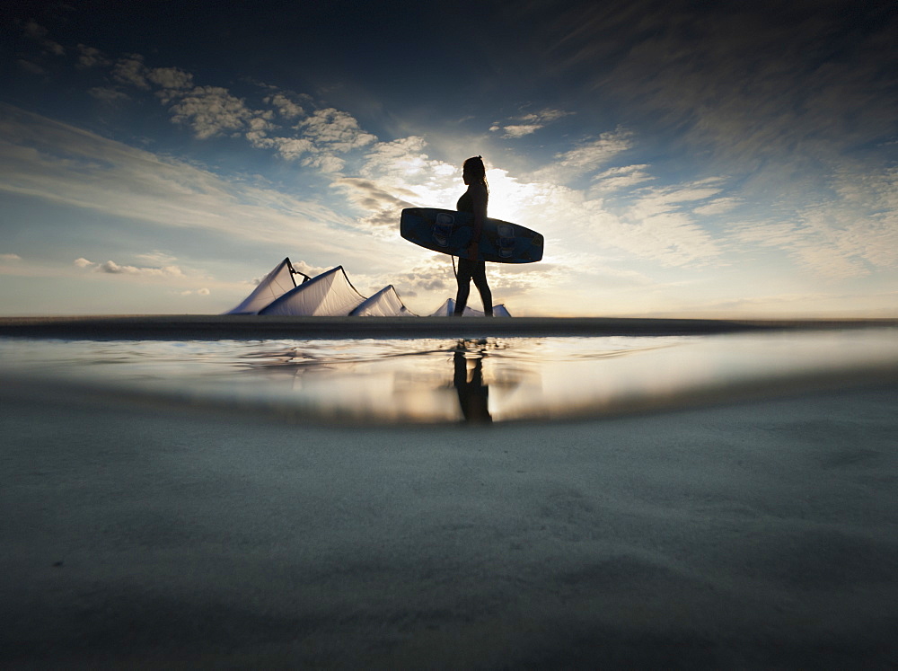 A Kitesurfer Walks Along The Beach At Sunset, Tarifa, Cadiz, Andalusia, Spain