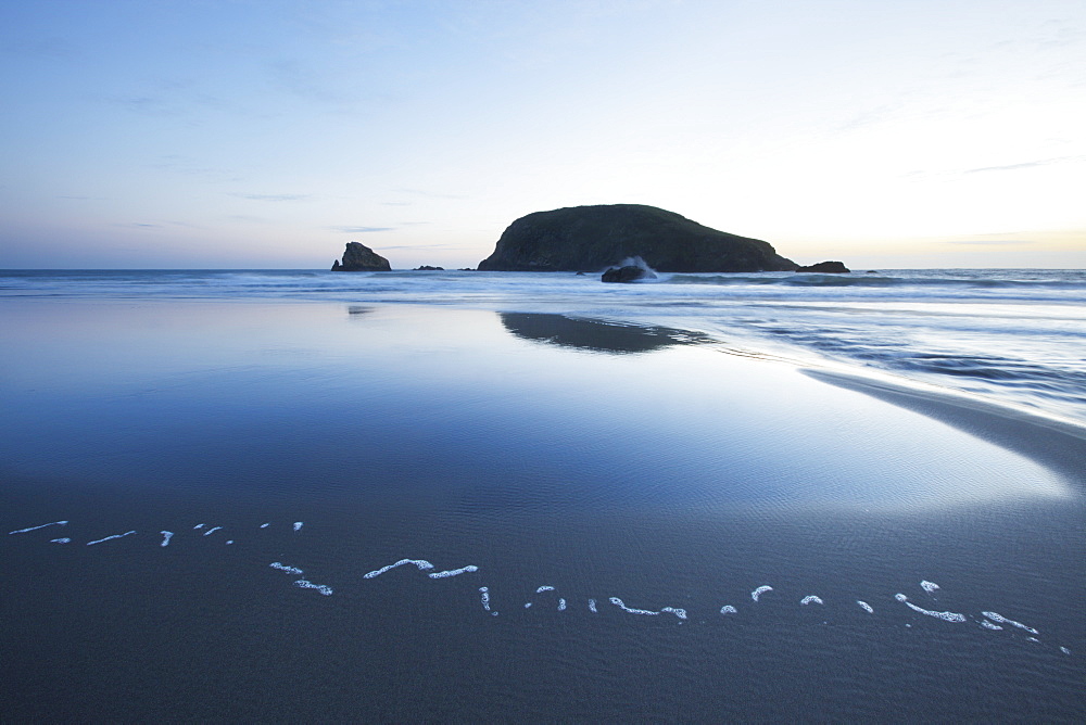 Pacific Ocean And Coast Of Oregon With A Large Rock At Sunset, Oregon, United States Of America