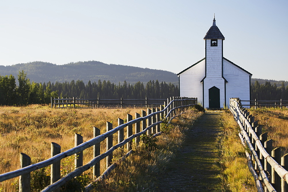 Old Wooden Church In Foothills With Wooden Fence And Blue Sky, Cochrane, Alberta, Canada