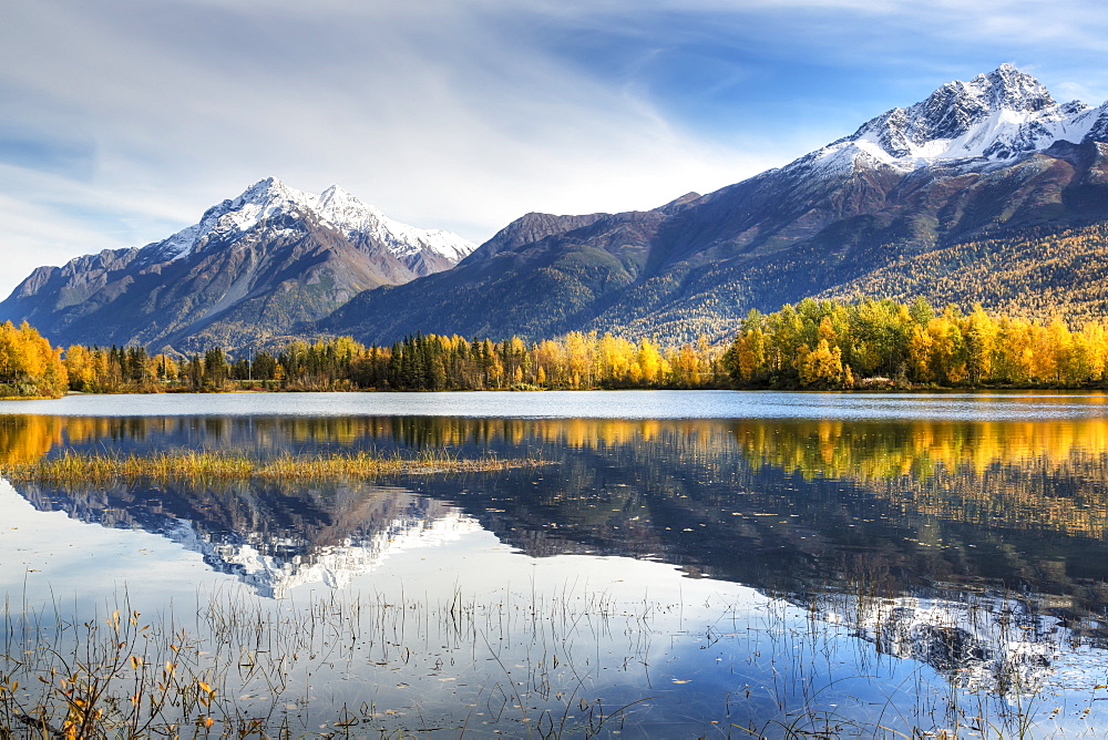 The Snowcapped Chugach Mountains And Autumn Foliage Reflecting In Reflections Lake Along The Glenn Highway In The Matanuska Susitna Valley, Alaska, United States Of America