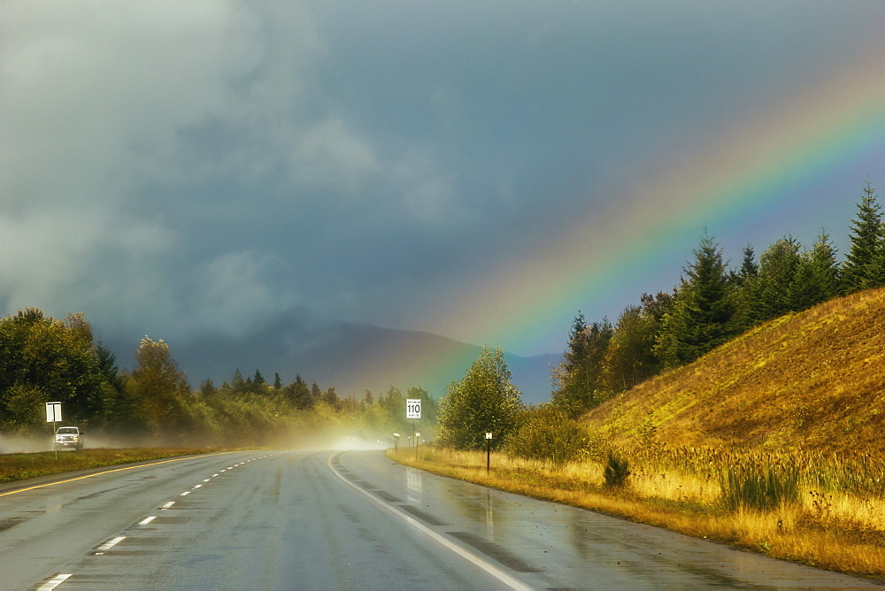 A Rainbow Comes From The Storm Clouds Right Onto The Highway Ahead, Parksville, British Columbia, Canada