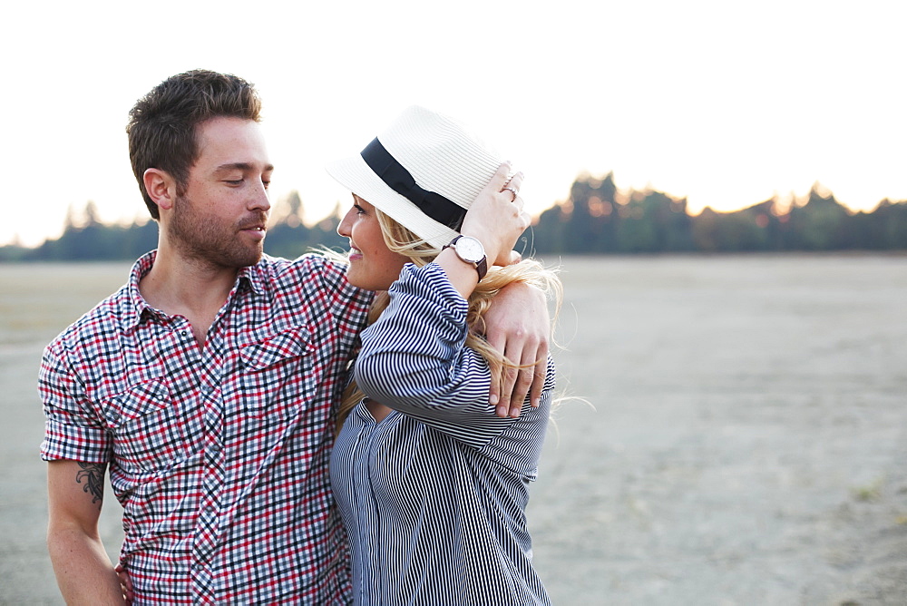 A Couple In An Embrace Along The Water's Edge, Victoria, British Columbia, Canada